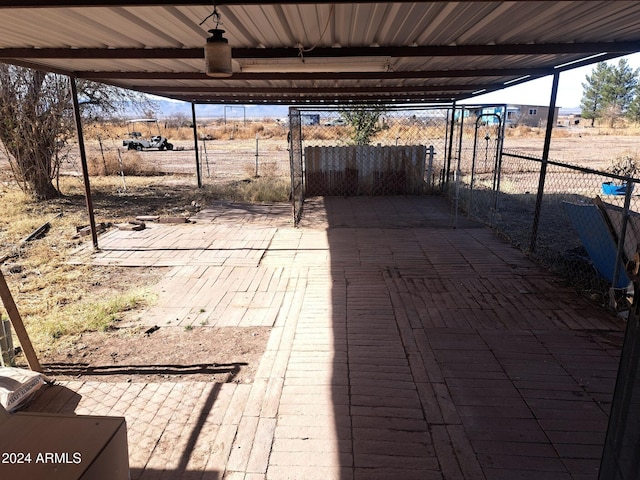 view of patio / terrace featuring fence and a rural view