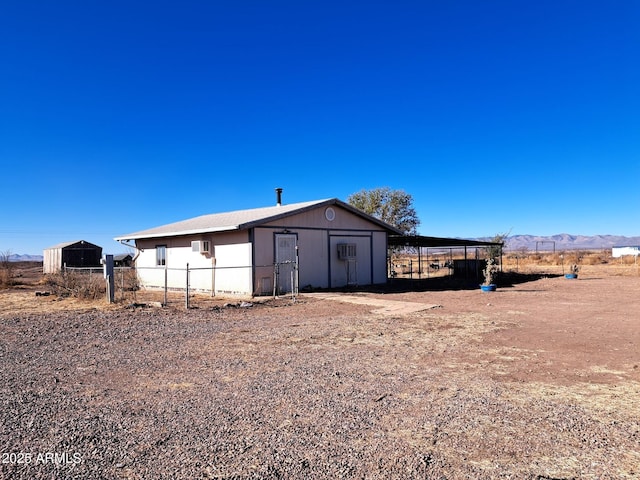 view of pole building with fence and a mountain view