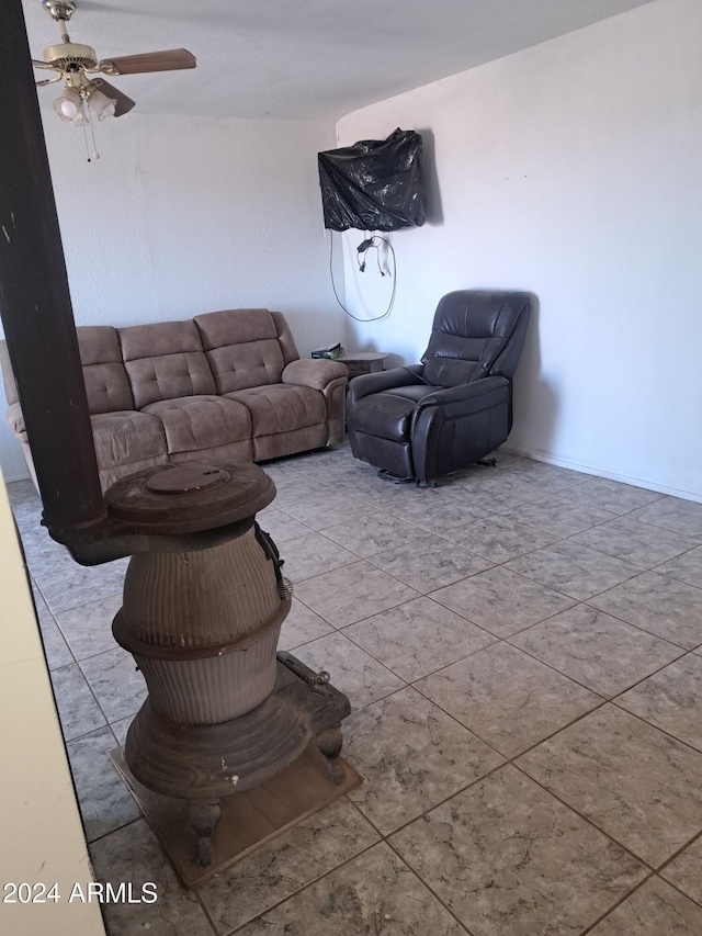 living area featuring light tile patterned floors and a ceiling fan