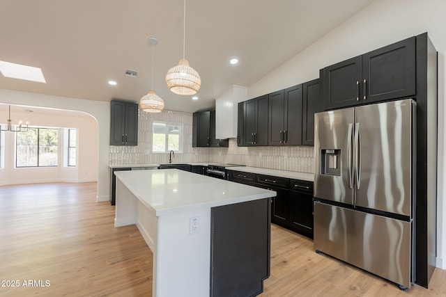 15038 E Greene Valley Dr, Fountain Hills, AZ 85268 - kitchen with tasteful backsplash, appliances with stainless steel finishes, visible vents, light countertops, and a center island