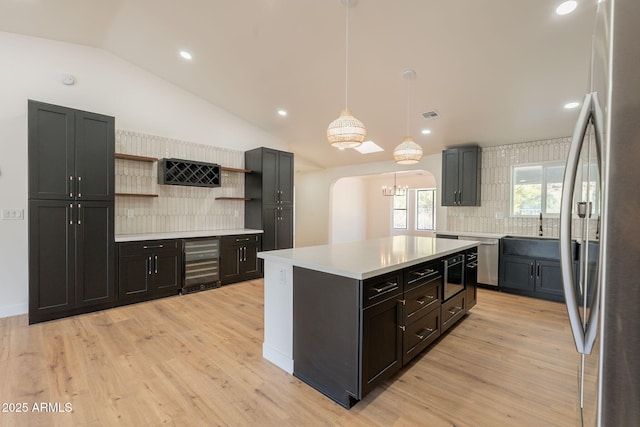 15038 E Greene Valley Dr, Fountain Hills, AZ 85268 - kitchen with wine cooler, open shelves, backsplash, light countertops, and appliances with stainless steel finishes
