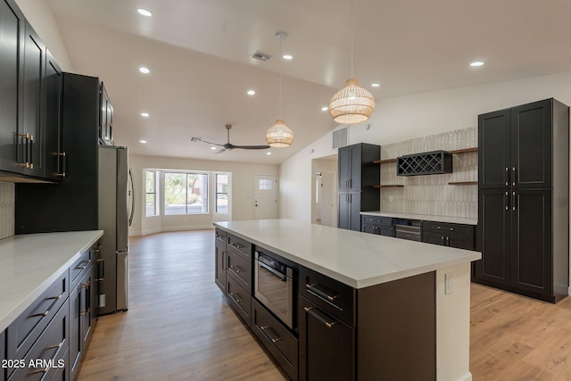 15038 E Greene Valley Dr, Fountain Hills, AZ 85268 - kitchen featuring light stone countertops, open shelves, visible vents, light wood-style flooring, and a kitchen island