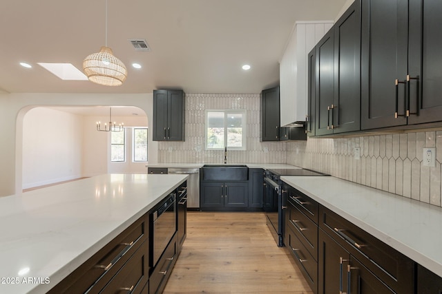 15038 E Greene Valley Dr, Fountain Hills, AZ 85268 - kitchen featuring light wood-style flooring, a sink, stainless steel appliances, an inviting chandelier, and backsplash