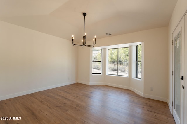 15038 E Greene Valley Dr, Fountain Hills, AZ 85268 - unfurnished room featuring an inviting chandelier, wood finished floors, visible vents, and baseboards