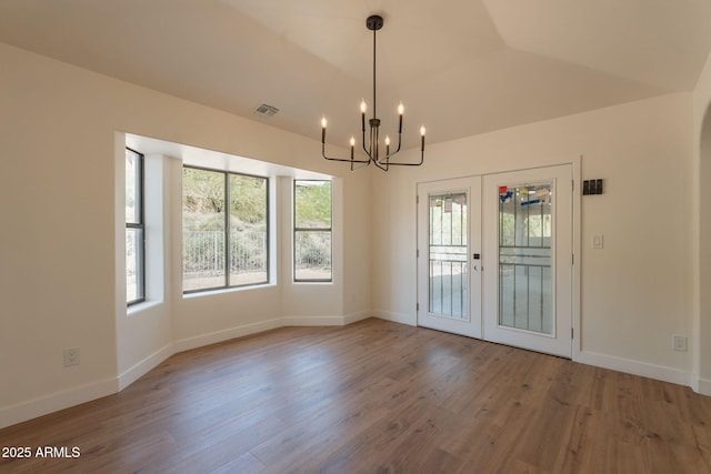15038 E Greene Valley Dr, Fountain Hills, AZ 85268 - unfurnished dining area with wood finished floors, a chandelier, baseboards, visible vents, and french doors