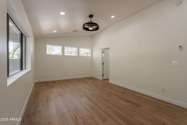 15038 E Greene Valley Dr, Fountain Hills, AZ 85268 - unfurnished room with baseboards, recessed lighting, wood finished floors, and lofted ceiling