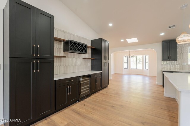 15038 E Greene Valley Dr, Fountain Hills, AZ 85268 - kitchen featuring an inviting chandelier, wine cooler, open shelves, backsplash, and light countertops