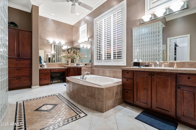 full bath with a ceiling fan, a towering ceiling, ornamental molding, a sink, and a bath