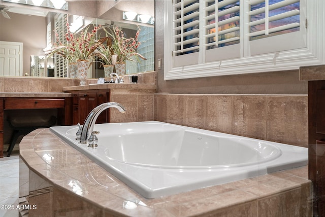 bathroom with a garden tub and tile patterned floors