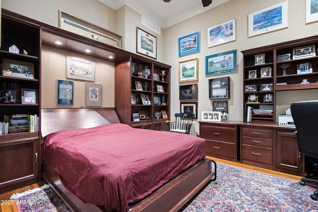 bedroom featuring light wood-type flooring and ornamental molding