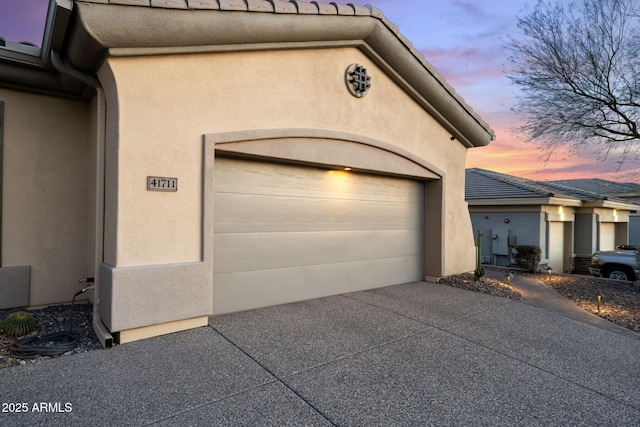 garage featuring concrete driveway