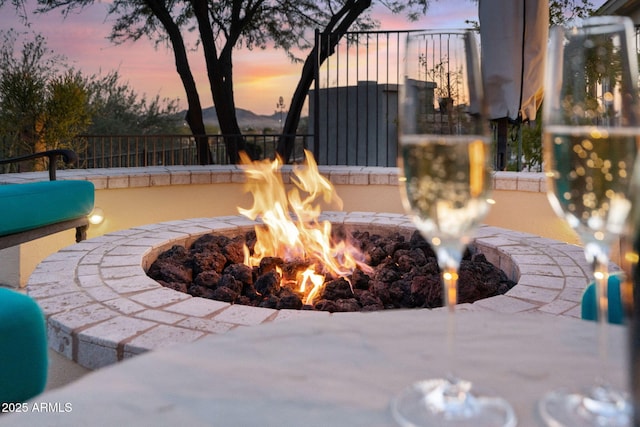 exterior space featuring a fire pit and fence