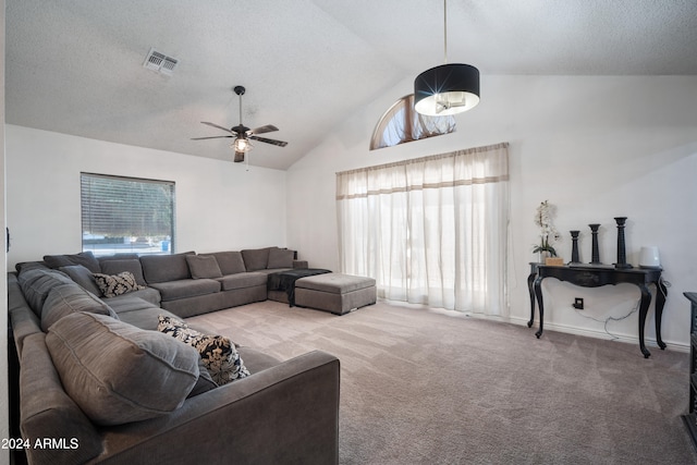 living room with light carpet, a textured ceiling, high vaulted ceiling, and ceiling fan