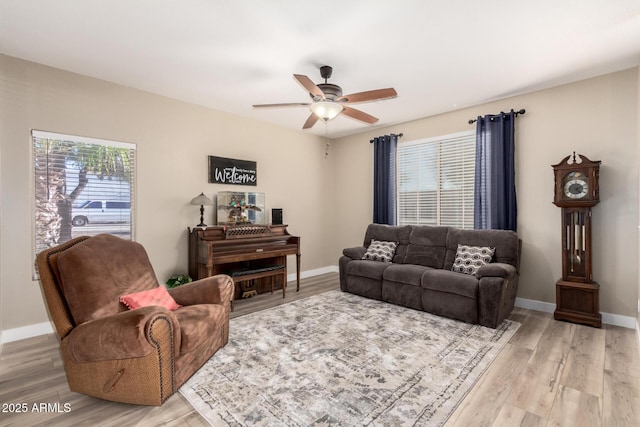 living room featuring ceiling fan, a healthy amount of sunlight, and light hardwood / wood-style floors