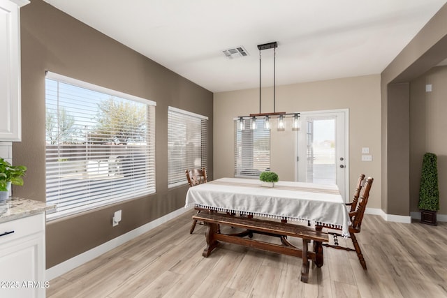 dining space with light wood-type flooring