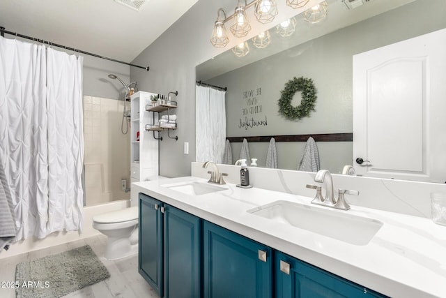 full bathroom with vanity, shower / tub combo, and toilet