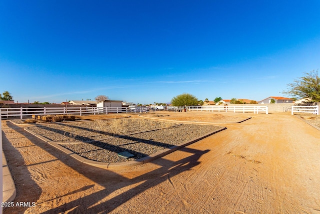 view of yard with a rural view