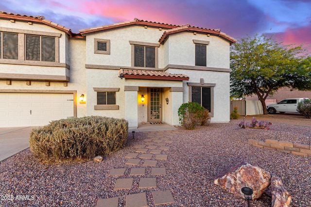 mediterranean / spanish-style home featuring a garage