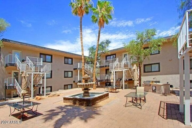 724 E Devonshire Ave Unit 108, Phoenix, AZ 85014 - surrounding community with stairs, a patio area, and an outdoor kitchen