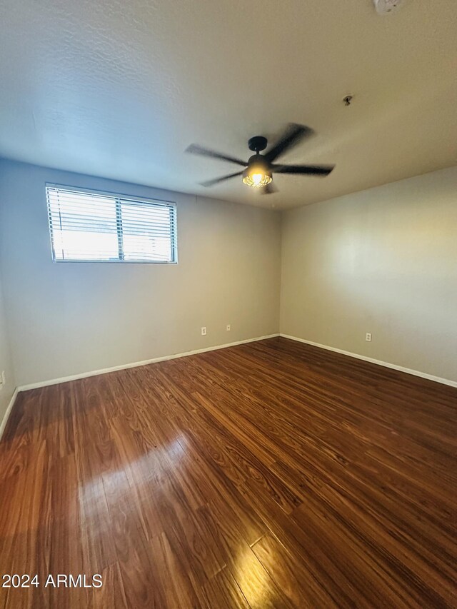 724 E Devonshire Ave Unit 108, Phoenix, AZ 85014 - spare room featuring dark wood-style flooring and a ceiling fan