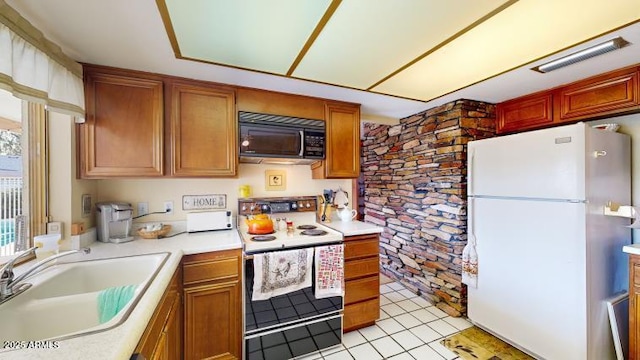 kitchen featuring white appliances, sink, and light tile patterned floors