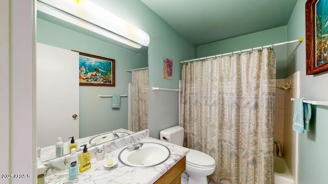 full bathroom featuring vanity, shower / bathtub combination with curtain, and toilet