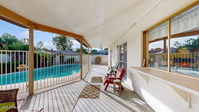 wooden deck featuring a fenced in pool and a patio area