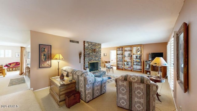 living room featuring light carpet and a fireplace