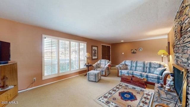 living room featuring a fireplace, carpet floors, and a textured ceiling