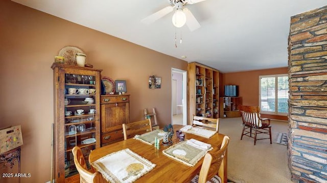 carpeted dining space featuring ceiling fan