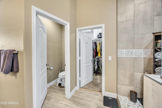 bathroom featuring hardwood / wood-style floors and toilet