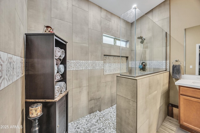 bathroom featuring vanity and tiled shower