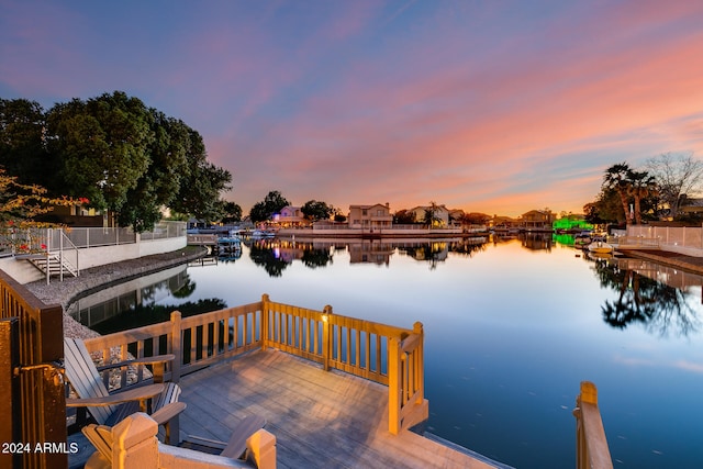 view of dock with a deck with water view