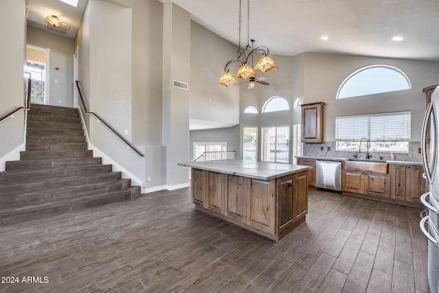 kitchen featuring dishwasher, a center island, pendant lighting, high vaulted ceiling, and dark hardwood / wood-style floors