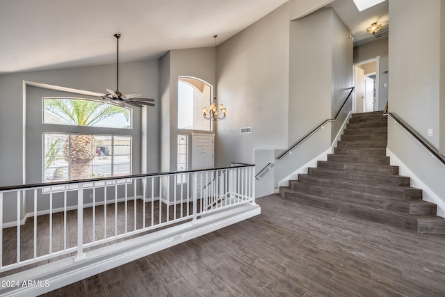 stairway featuring lofted ceiling, hardwood / wood-style flooring, and ceiling fan