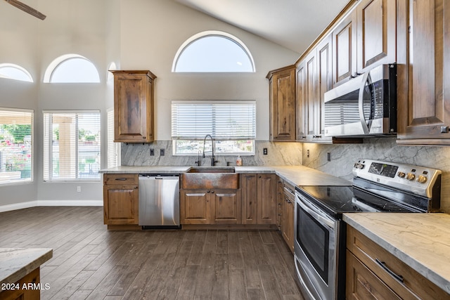 kitchen featuring appliances with stainless steel finishes, dark hardwood / wood-style floors, and a healthy amount of sunlight