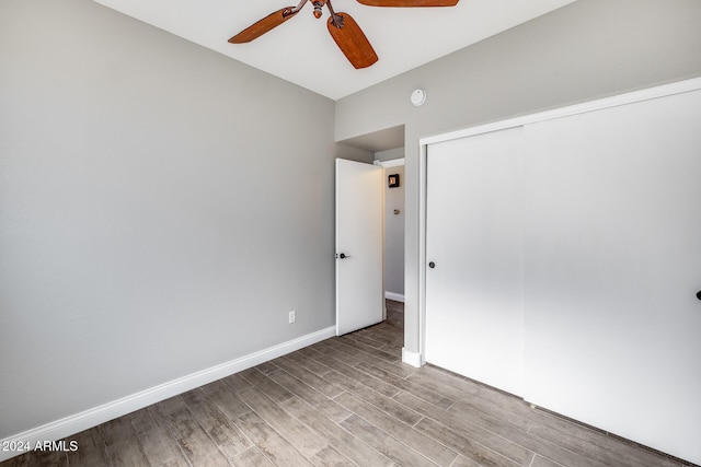 unfurnished bedroom featuring a closet, light wood-type flooring, and ceiling fan