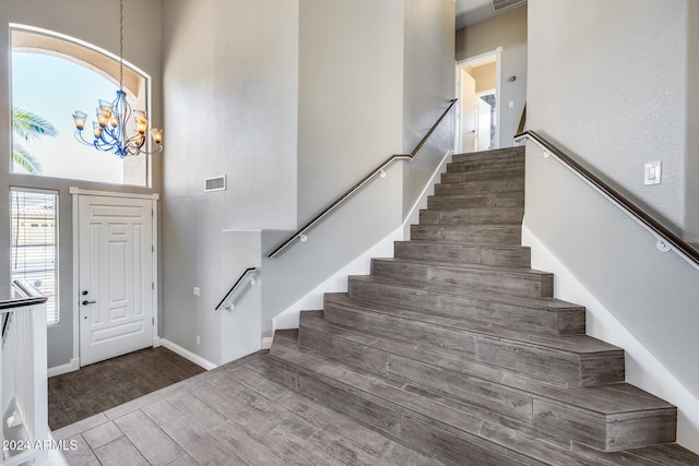 foyer entrance with dark wood-type flooring and a notable chandelier