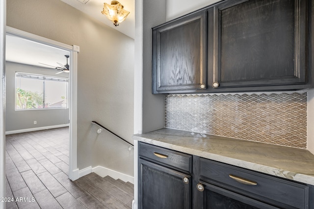 kitchen featuring tasteful backsplash, ceiling fan, and dark hardwood / wood-style flooring