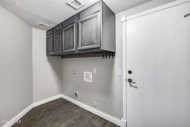 laundry room with hookup for a washing machine, gas dryer hookup, cabinets, and dark hardwood / wood-style flooring