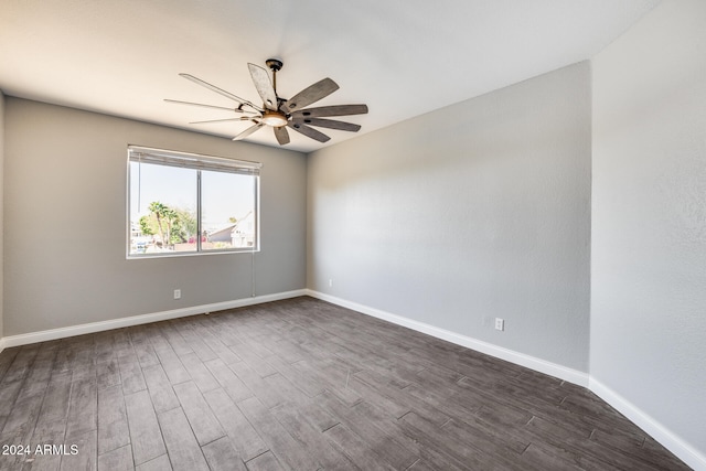 empty room with dark hardwood / wood-style floors and ceiling fan