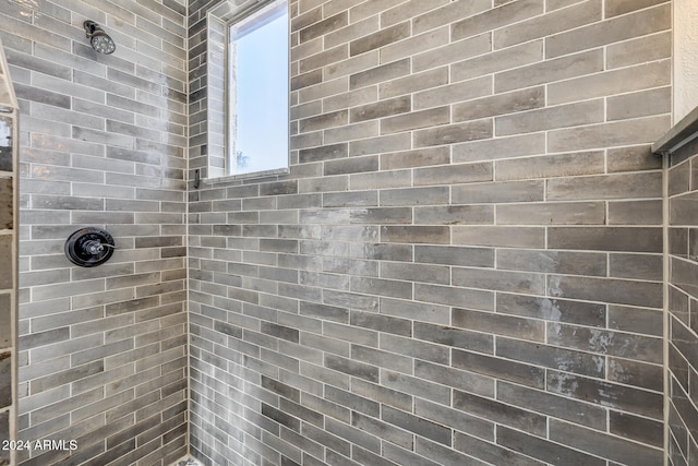 bathroom with tiled shower