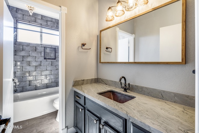 full bathroom with vanity, hardwood / wood-style flooring, toilet, and shower / bathtub combination