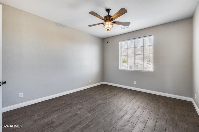 spare room featuring ceiling fan and dark hardwood / wood-style floors