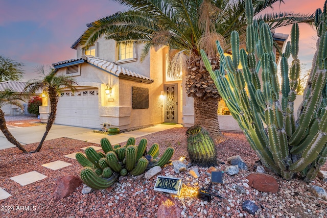 mediterranean / spanish-style home with a garage