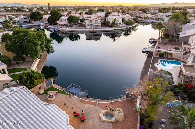 aerial view at dusk with a water view