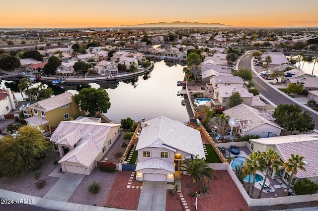 aerial view at dusk with a water view