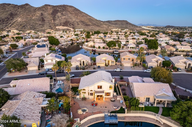 birds eye view of property with a water and mountain view