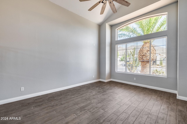 empty room featuring vaulted ceiling, ceiling fan, and dark hardwood / wood-style flooring