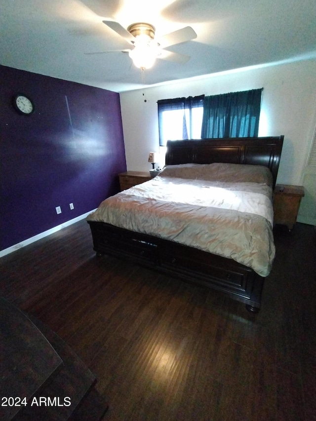 bedroom with ceiling fan and dark hardwood / wood-style flooring